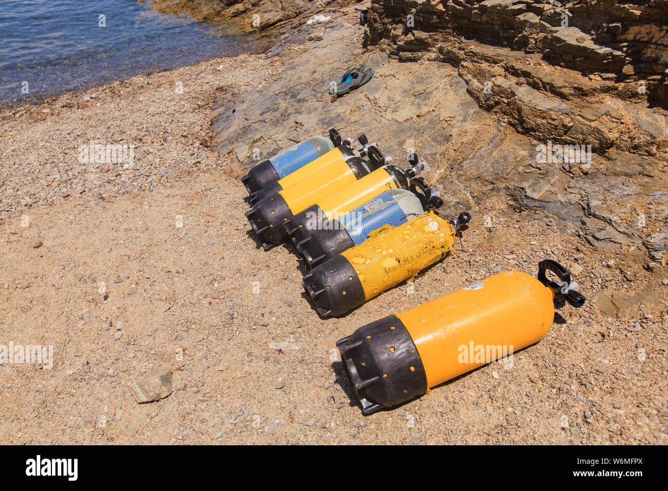 Scuba diving compressed air tanks on sand beach. Summer holiday