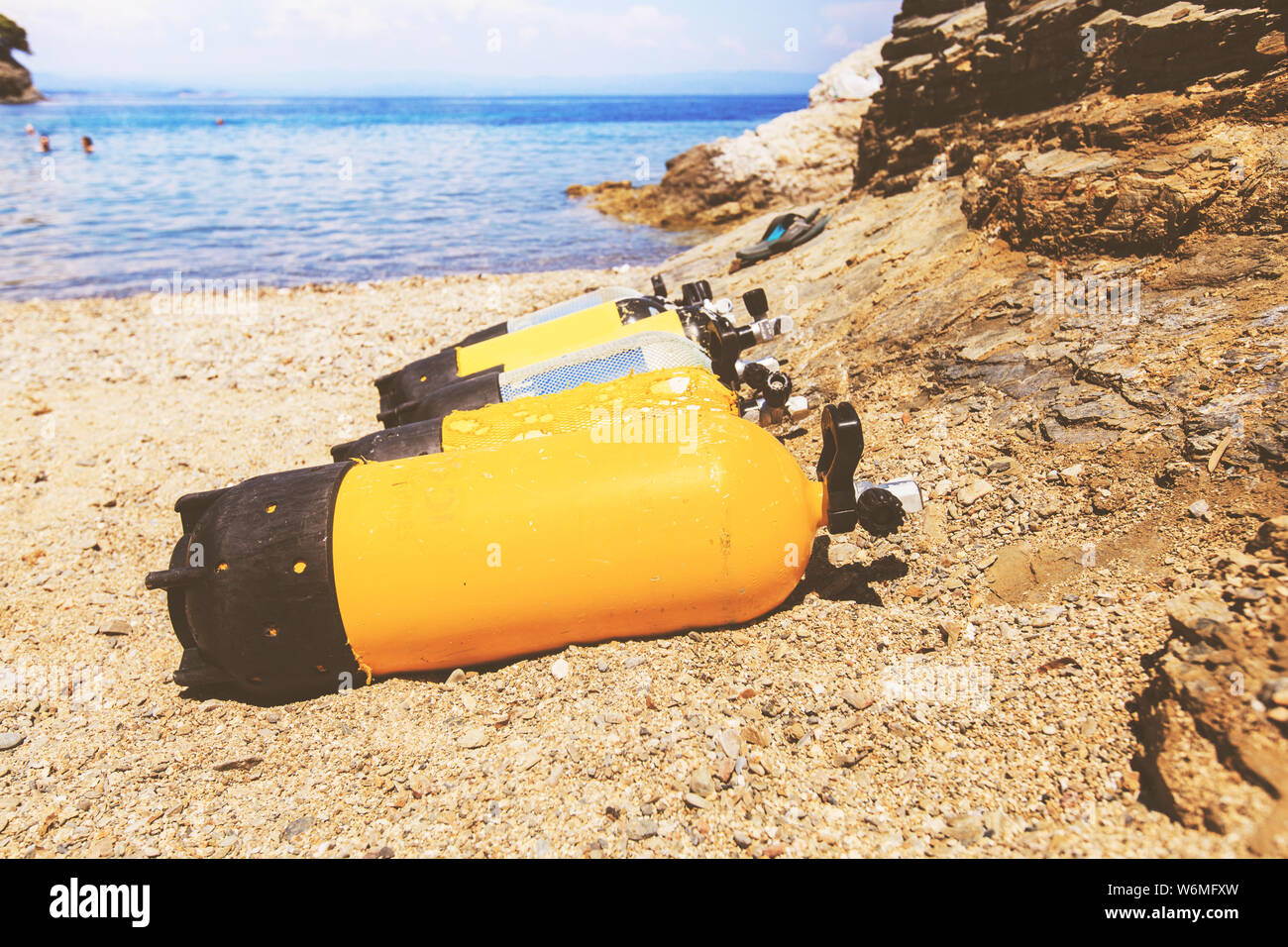 Scuba diving compressed air tanks on sand beach. Summer holiday