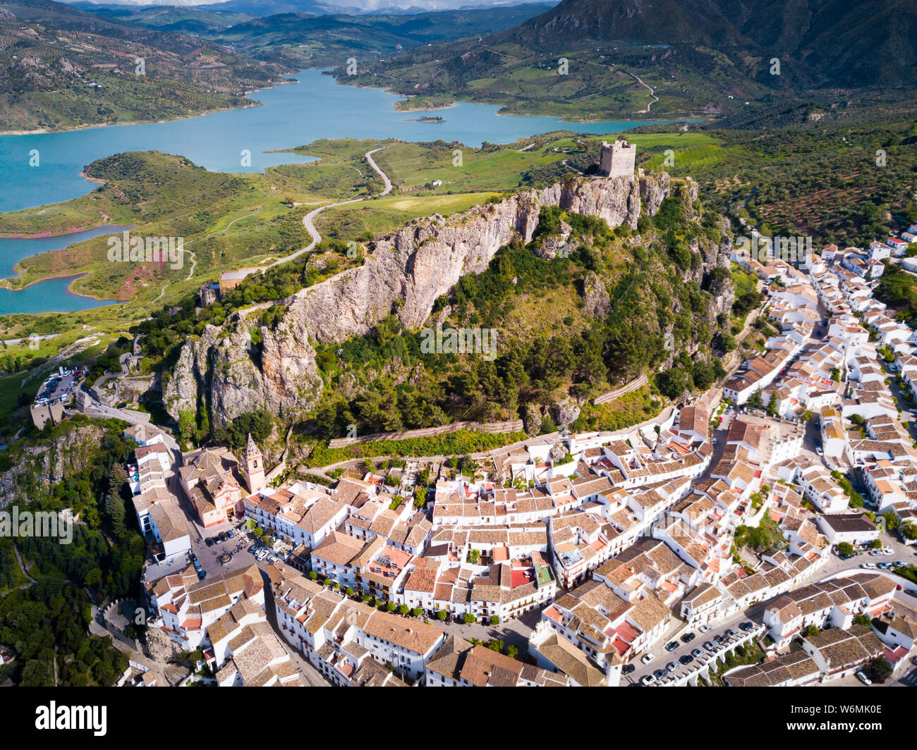 Aerial view of Zahara de la Sierra city with fortified castle on rocky ...
