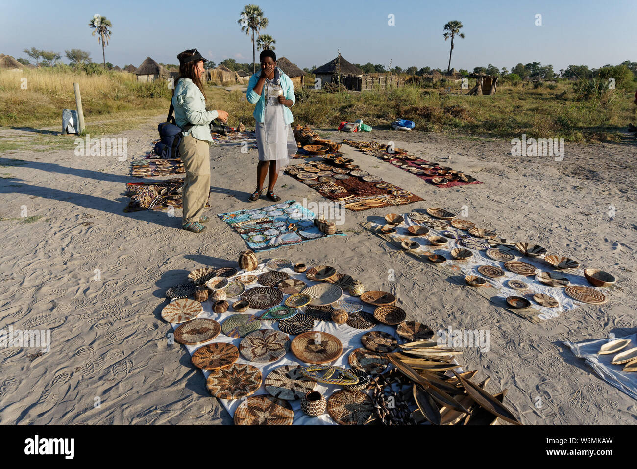 Okavango Delta, Okavango/Botswana - May 30, 2017: A tourist buys some souvenirs at a village basket market. Stock Photo