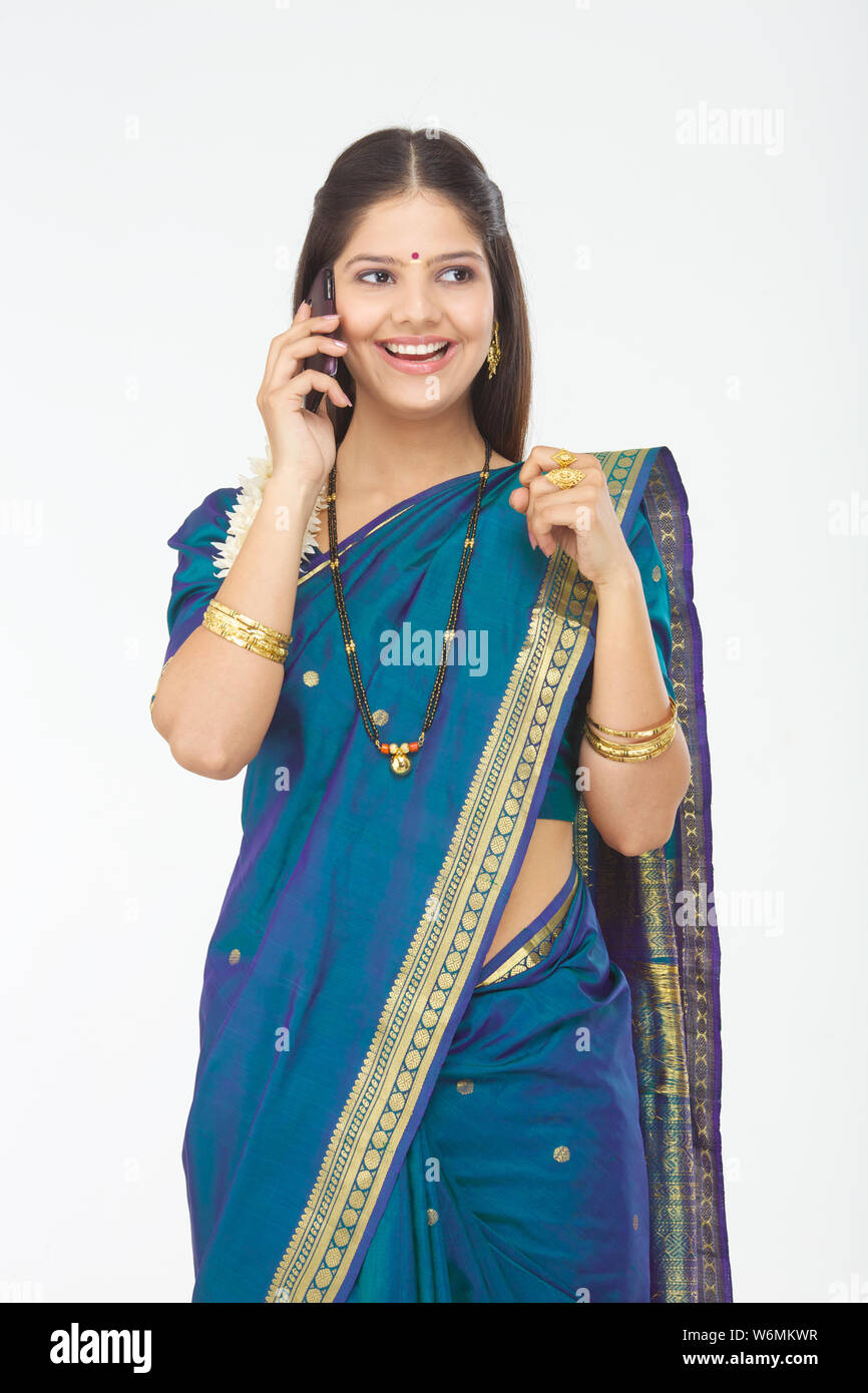 South Indian woman talking on mobile phone and smiling Stock Photo - Alamy