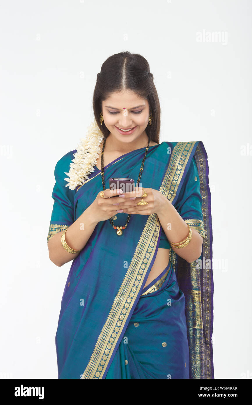 South Indian woman text messaging and smiling Stock Photo - Alamy