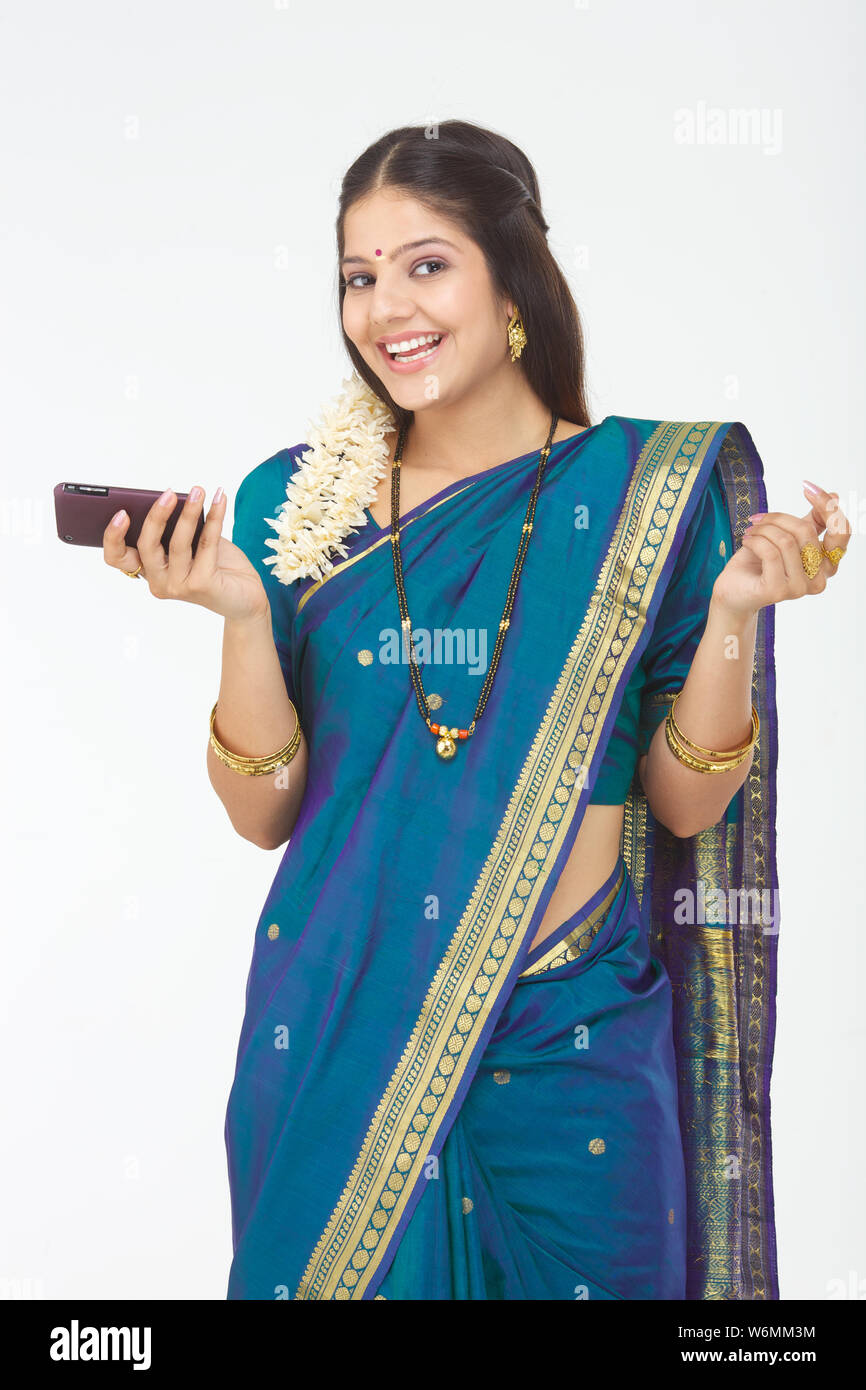 South Indian woman holding mobile phone and smiling Stock Photo - Alamy