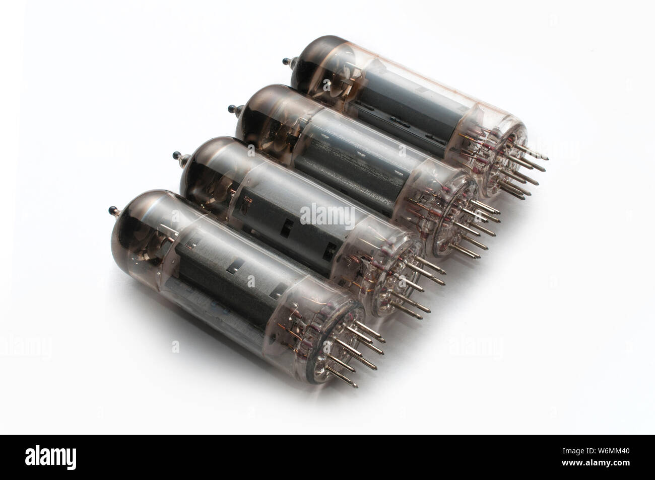 Set of four guitar amplifier power tubes on white background Stock