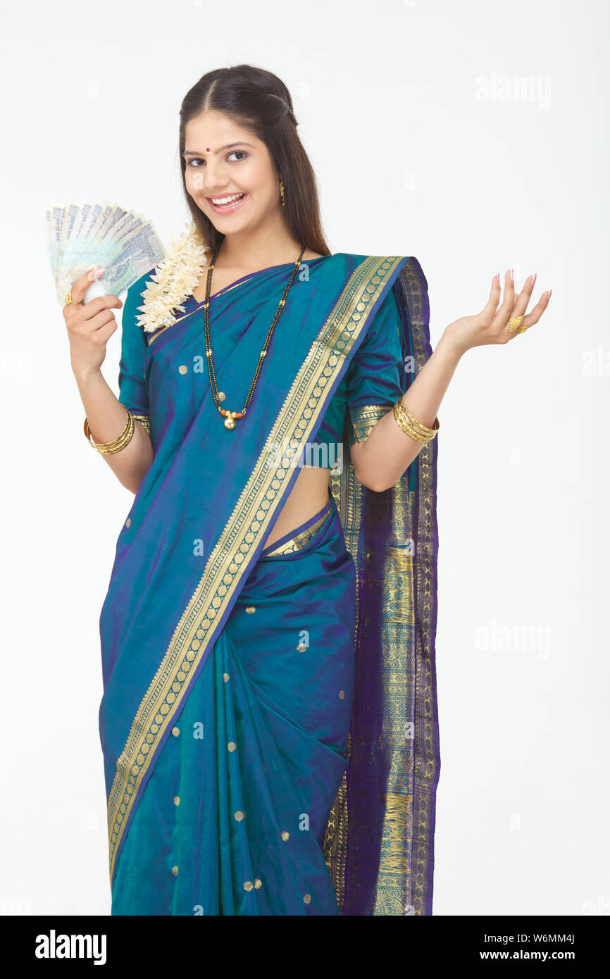 South Indian woman showing banknotes and smiling Stock Photo - Alamy