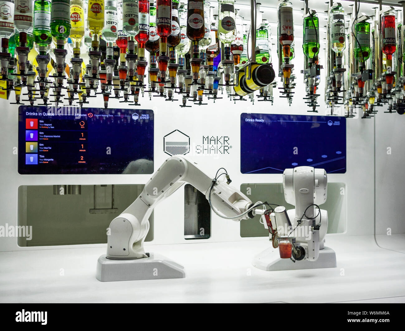 Makr shakr: 2 robotic arms make a variety of cocktails to order. AI, artificial intelligence. Exhibition at the Barbican London. Stock Photo
