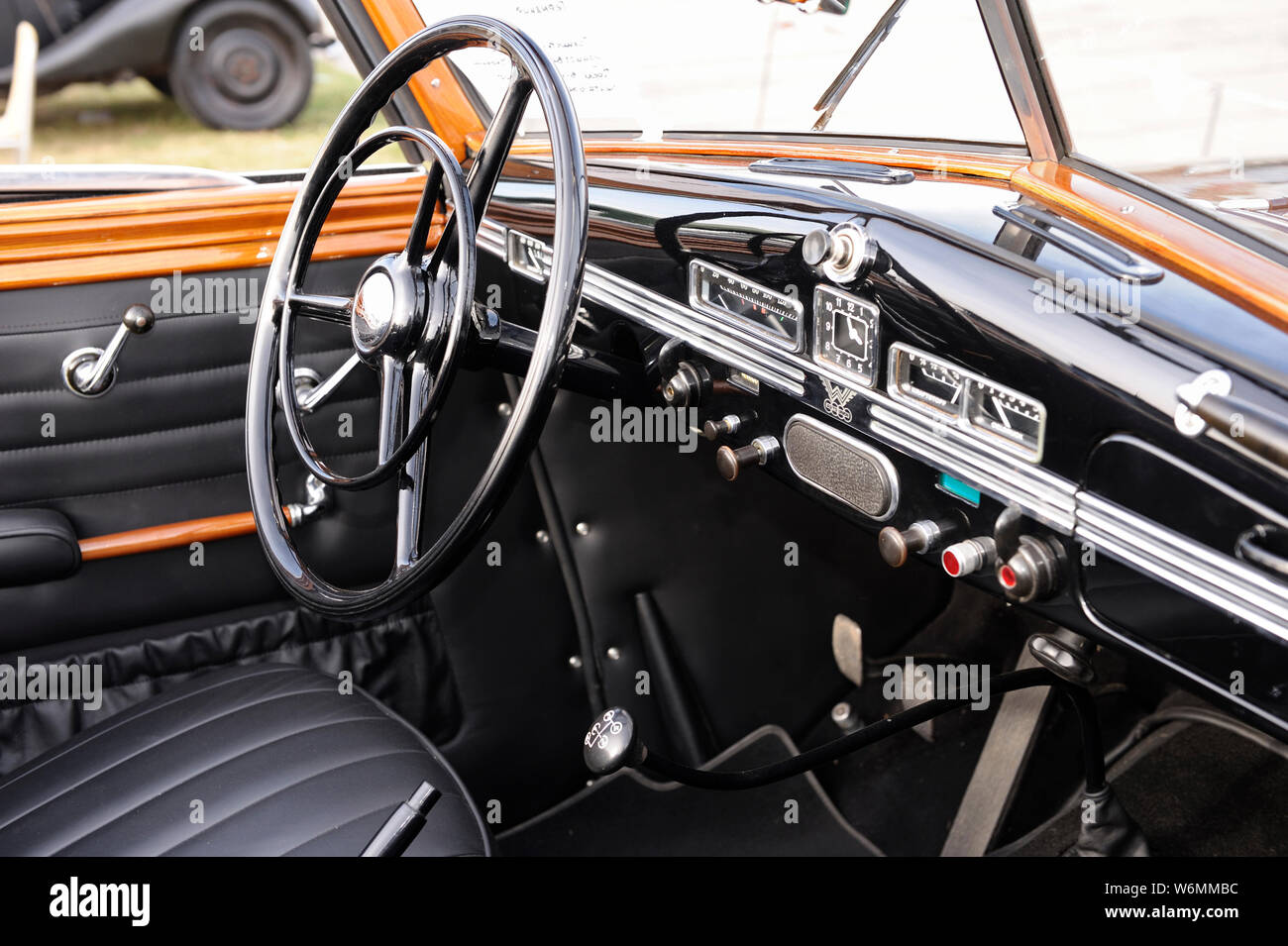 Interior of an old car steering wheel, dashboard, gear shift, glove