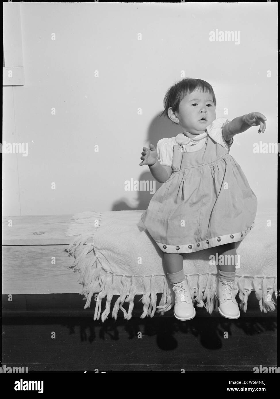 Tule Lake Relocation Center, Newell, California. This picture of an evacuee child was taken for eva . . .; Scope and content:  The full caption for this photograph reads: Tule Lake Relocation Center, Newell, California. This picture of an evacuee child was taken for evacuee use. This picture is interesting from a documentary angle, however, for it shows the doll-like features of the Japanese children. Stock Photo