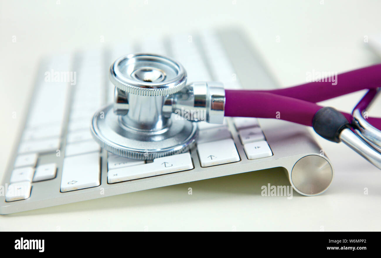 Stethoscope lying on a table on an open book. Stock Photo