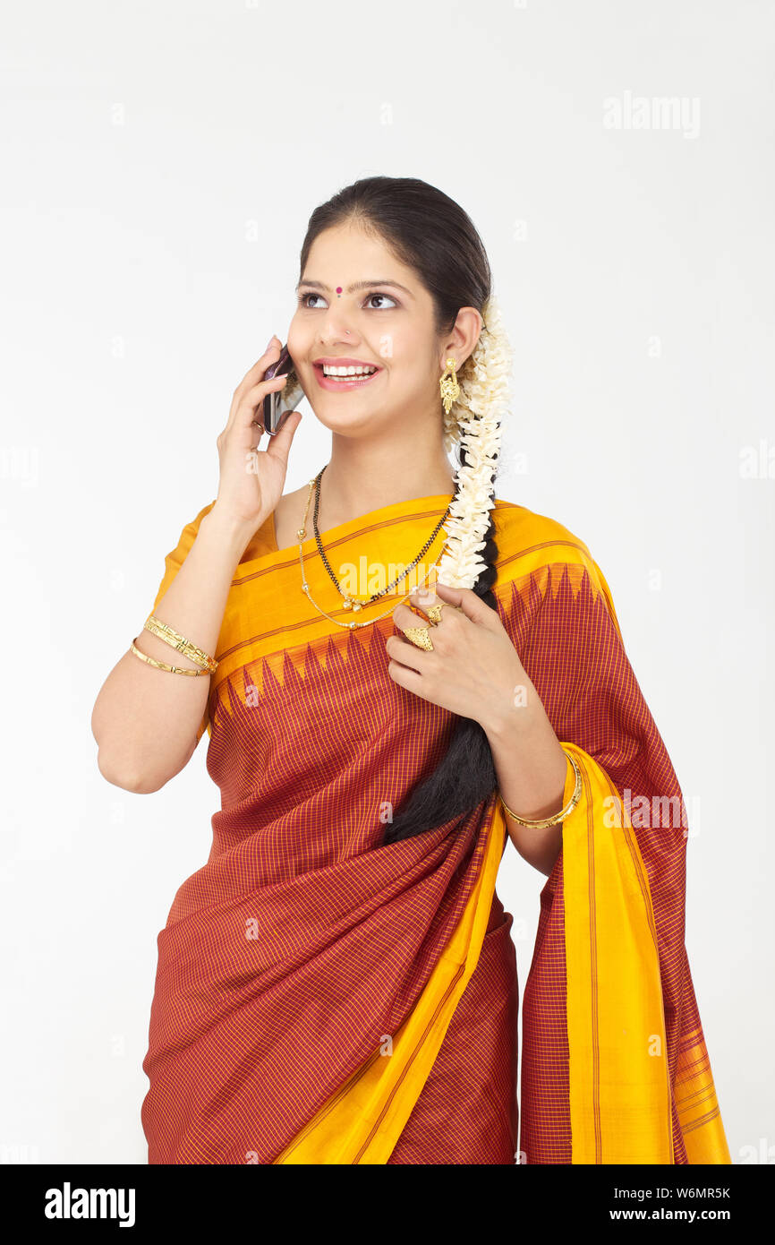 South Indian woman talking on a mobile phone and smiling Stock Photo ...