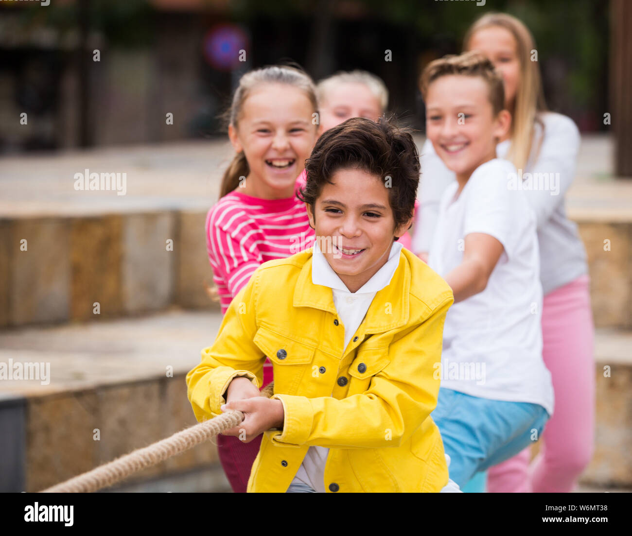 Children are pulling rope in the park Stock Photo - Alamy