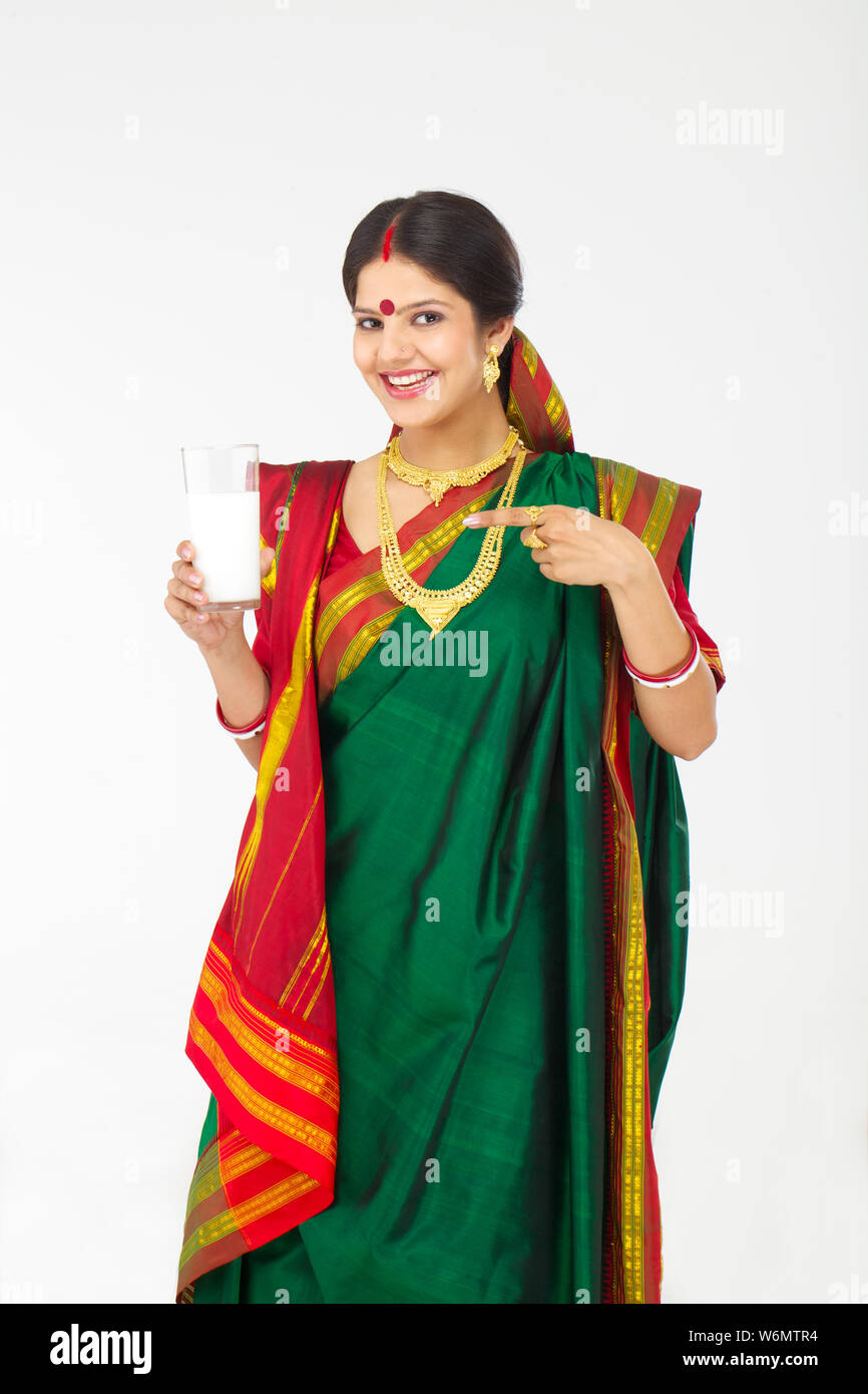 Bengali showing a glass of milk and smiling Stock Photo Alamy