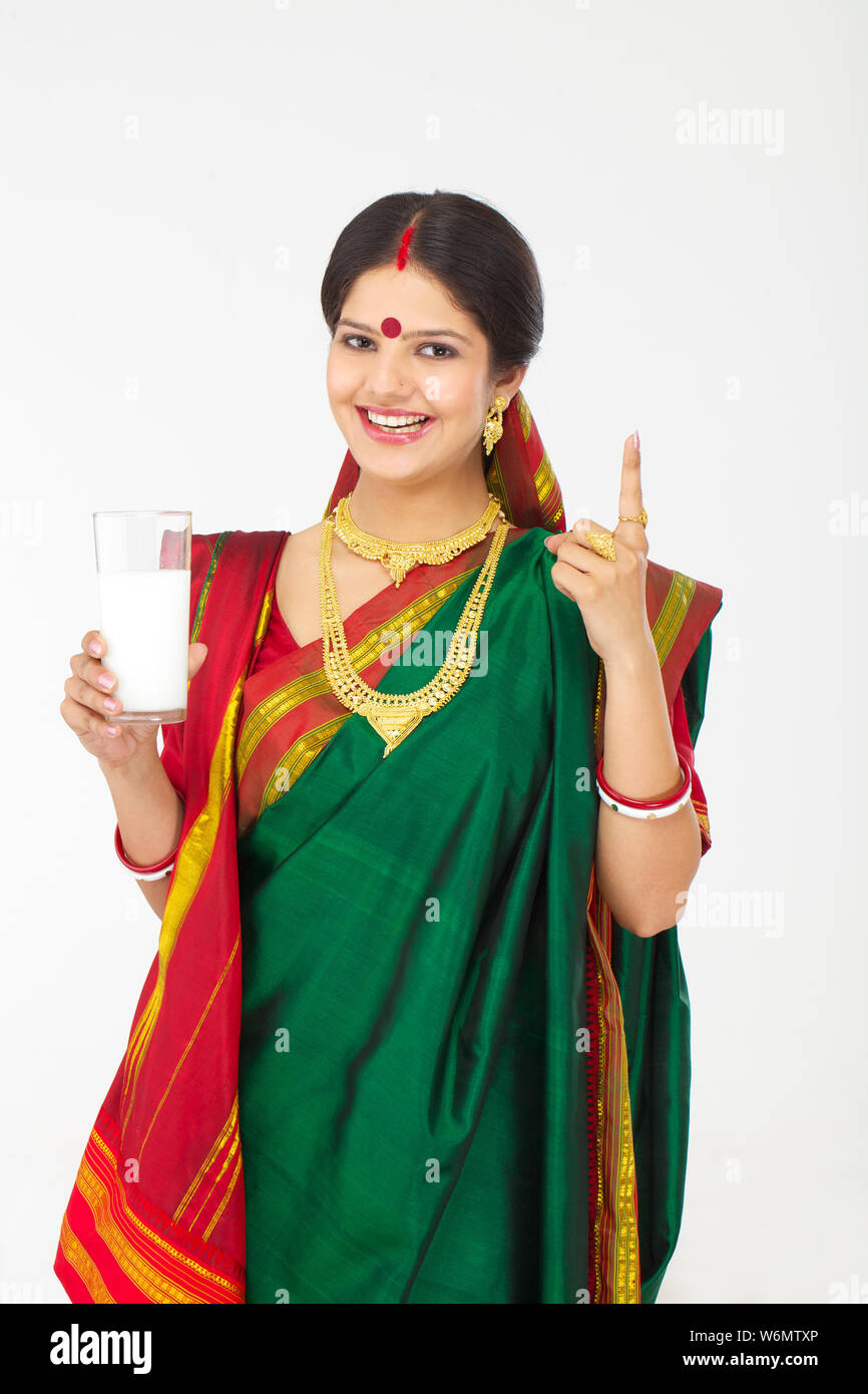 Bengali woman holding a glass of milk