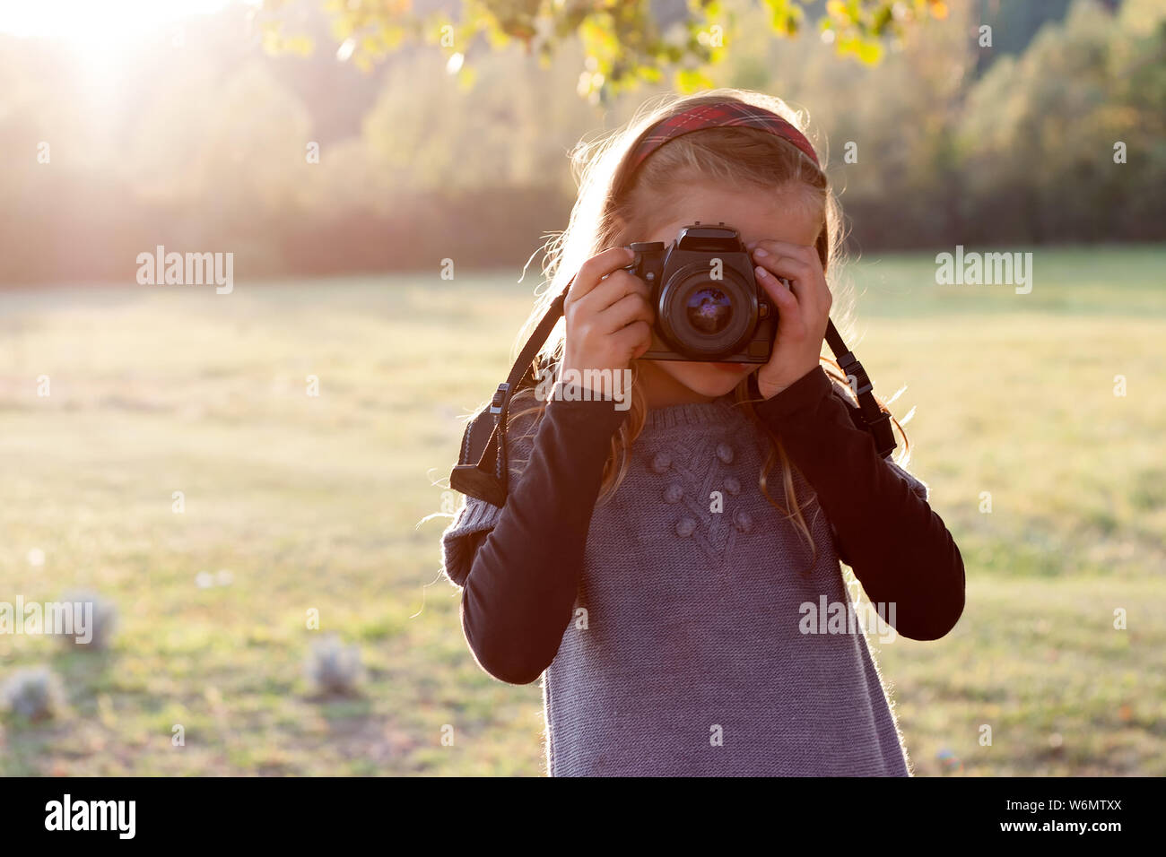 Portrait of a young girl, holding a photo camera Stock Photo