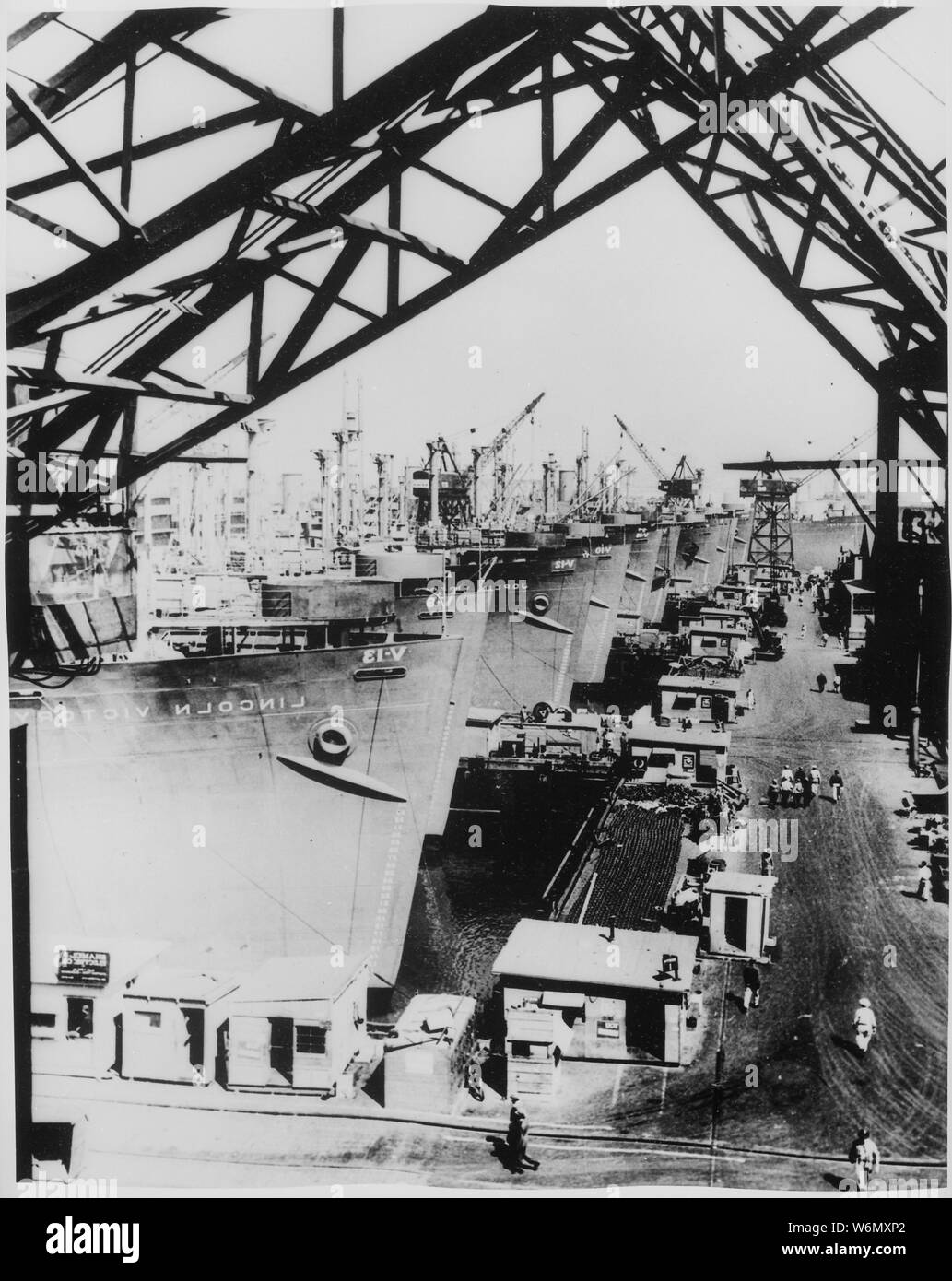 Victory cargo ships are lined up at a U.S. west coast shipyard for