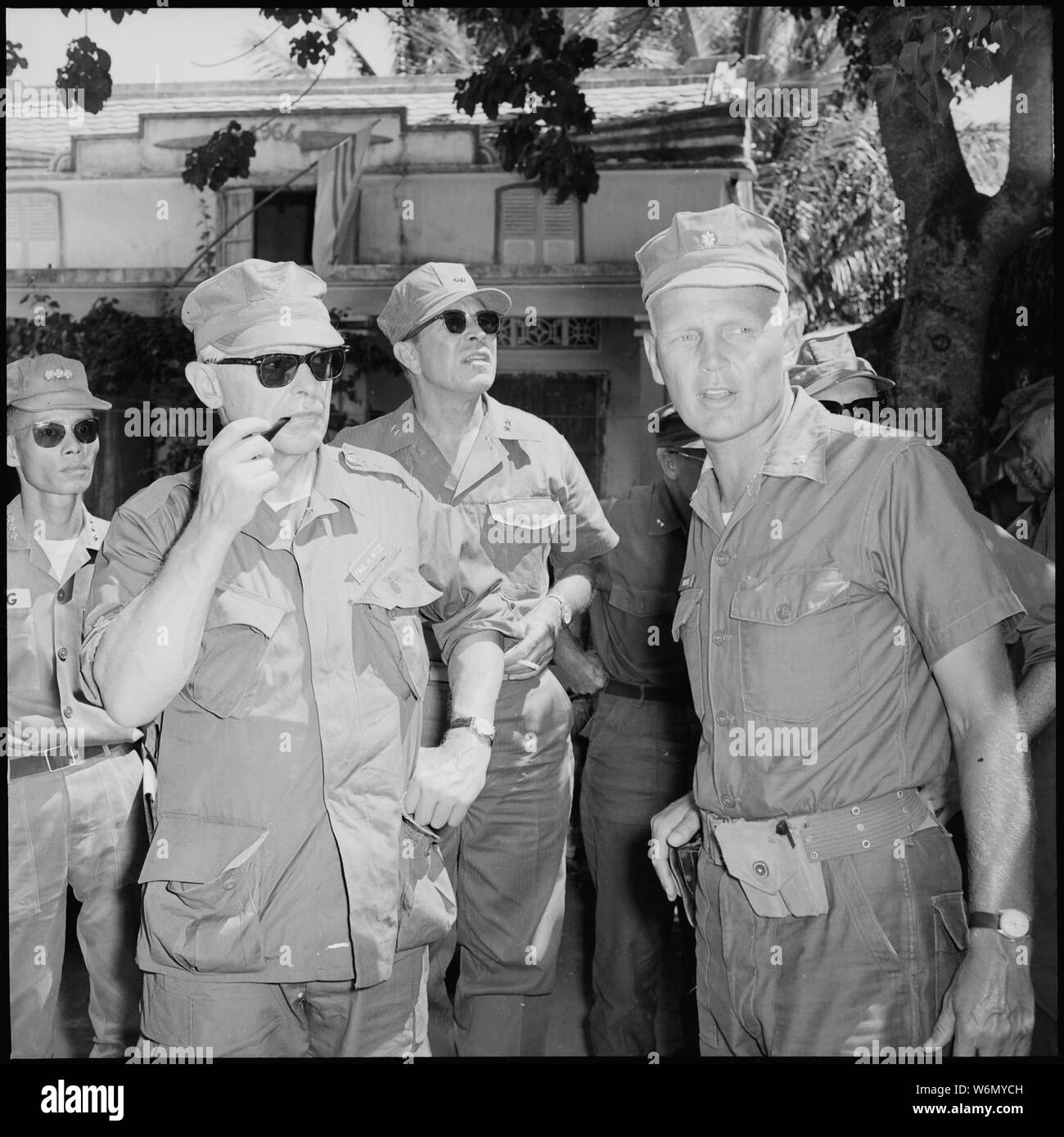 Vietnam....Lieutenant Colonel F.S. Wood, commanding officer, 1st Battalion, 7th Marine Regiment, shows Secretary of the Navy Paul H. Nitze and Major General Lewis J. Fields part of the command post area. Stock Photo