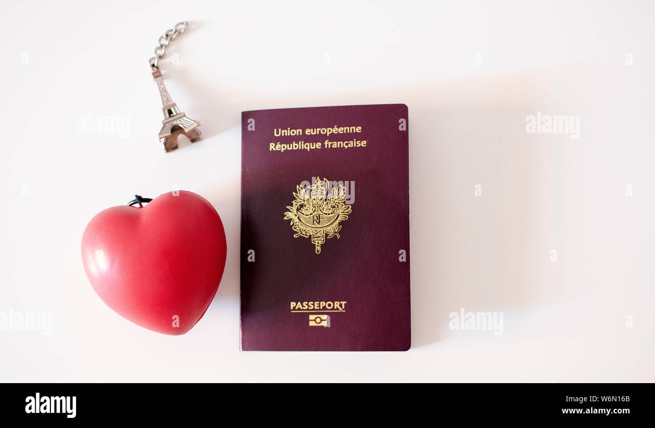French passport with a miniature of Eiffel Tower and a red heart Stock Photo