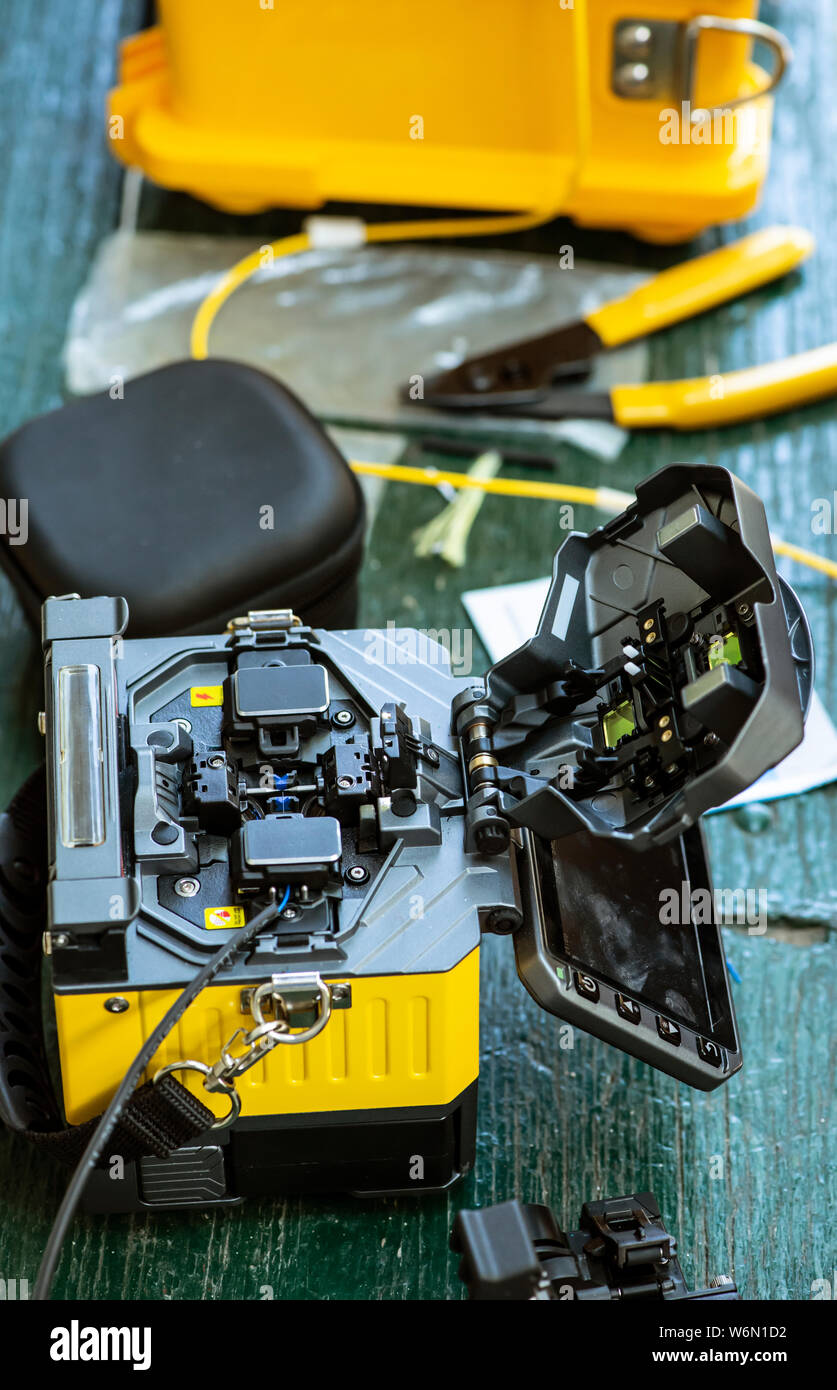 Device for mounting optical cable. Optical internet Technology concept. Optical fiber assembly. Stock Photo