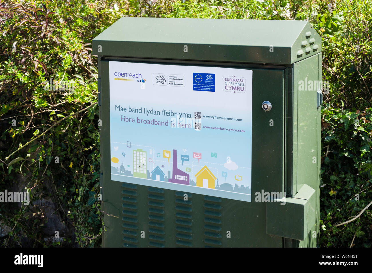 BT Openreach superfast fibre broadband green junction box in a rural Welsh community. Llanbedrgoch, Isle of Anglesey, north Wales, UK, Britain Stock Photo