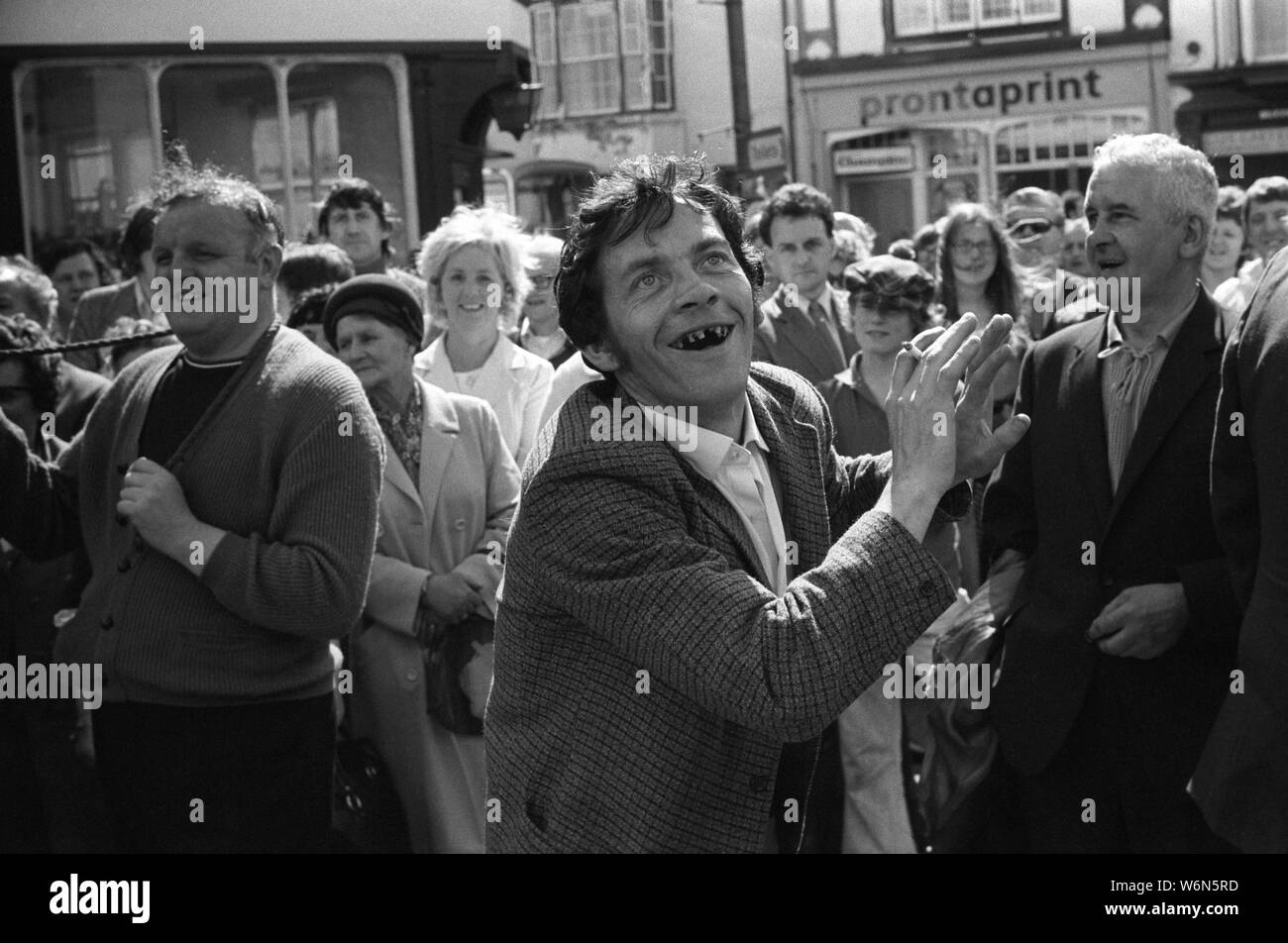 Gap tooth rotten teeth 1970s UK. Bad dental care smoker smoking cigarettes with cigarette in hand, smiling laughing a coal miner dances to the sound of a colliery silver bands, at the traditional annual Durham Miners Gala. County Durham, England 1974 HOMER SYKES Stock Photo