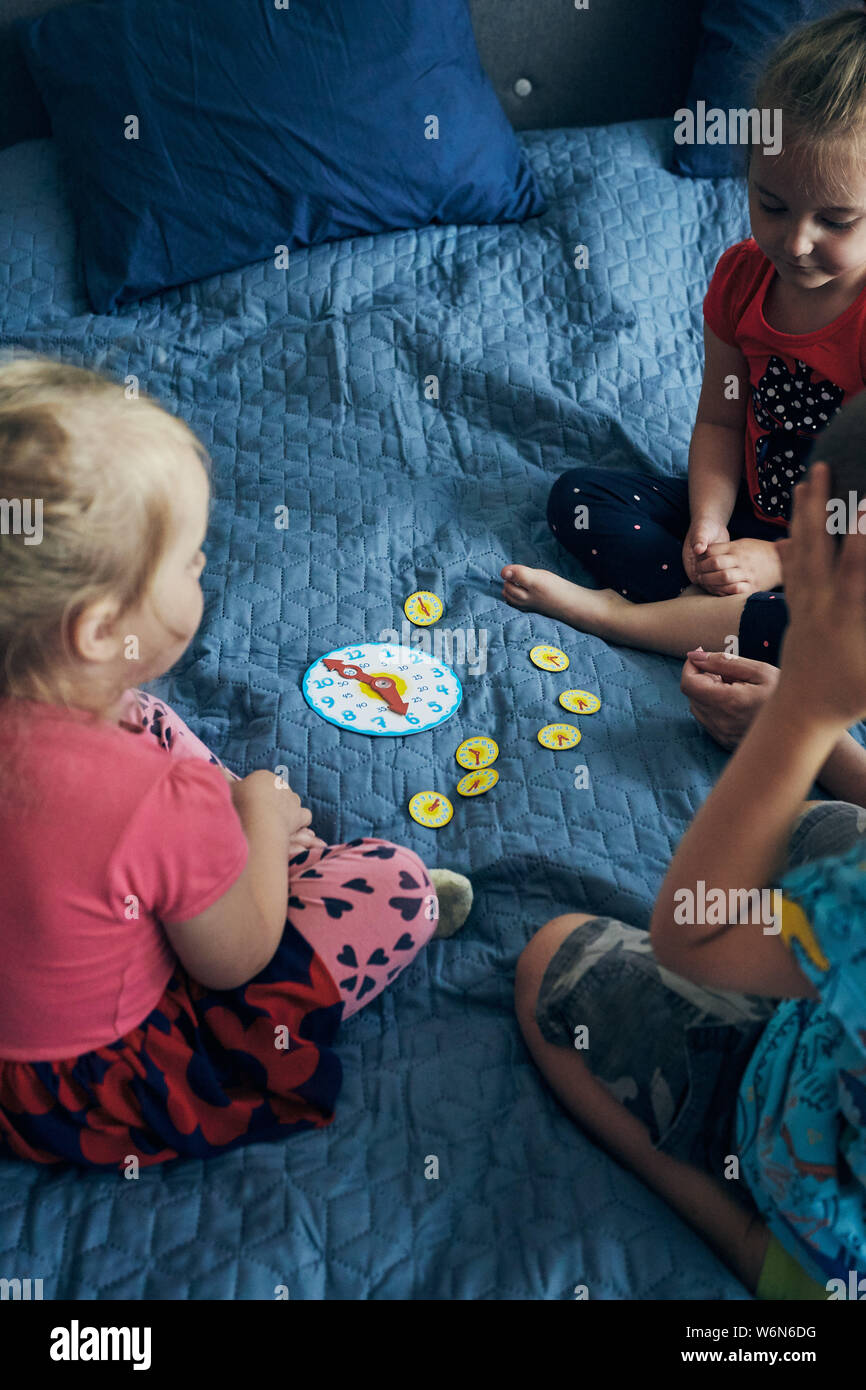 Kids learning how to tell time from clock and set the hands in the