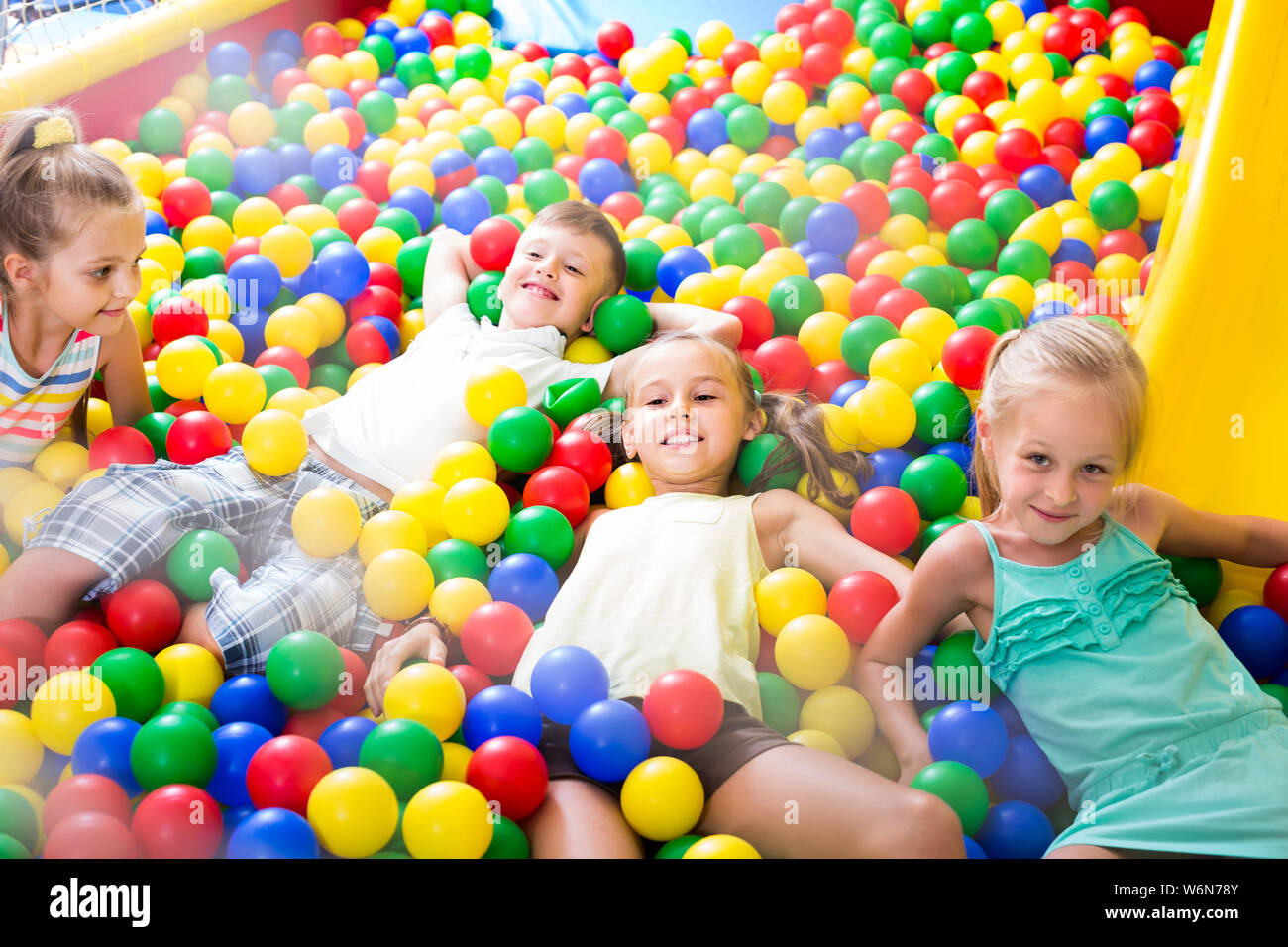 Group of kids in elementary school age playing on playground with
