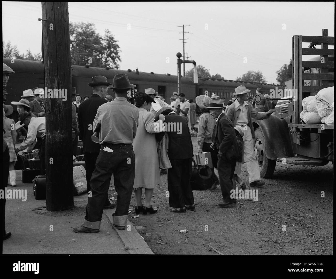 Woodland, California. Women at railroad station on morning of departure of persons of Japanese ance . . .; Scope and content:  The full caption for this photograph reads: Woodland, California. Women at railroad station on morning of departure of persons of Japanese ancestry from this agricultural community to the Merced Assembly center. The woman in the dark slack suit is one of the few exhibiting grief on leaving. Stock Photo