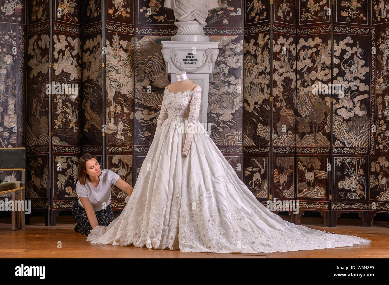 Oxford, UK. 2nd August. 2019. Lady Blandford's Dress ,the first Dolce & Gabbana  wedding dress for a UK bride in the UK.,Blenheim Palace Assistant House  manager Carmen Alvarez prepares the dress for