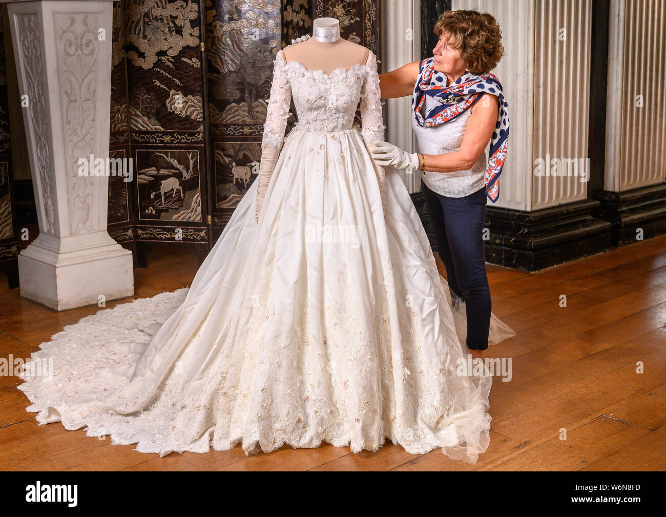 Oxford, UK. 2nd August. 2019. Lady Blandford's Dress ,the first Dolce & Gabbana  wedding dress for a UK bride in the UK.,Social Historian Antonia Keaney at  Blenheim Palace preparing the dress for