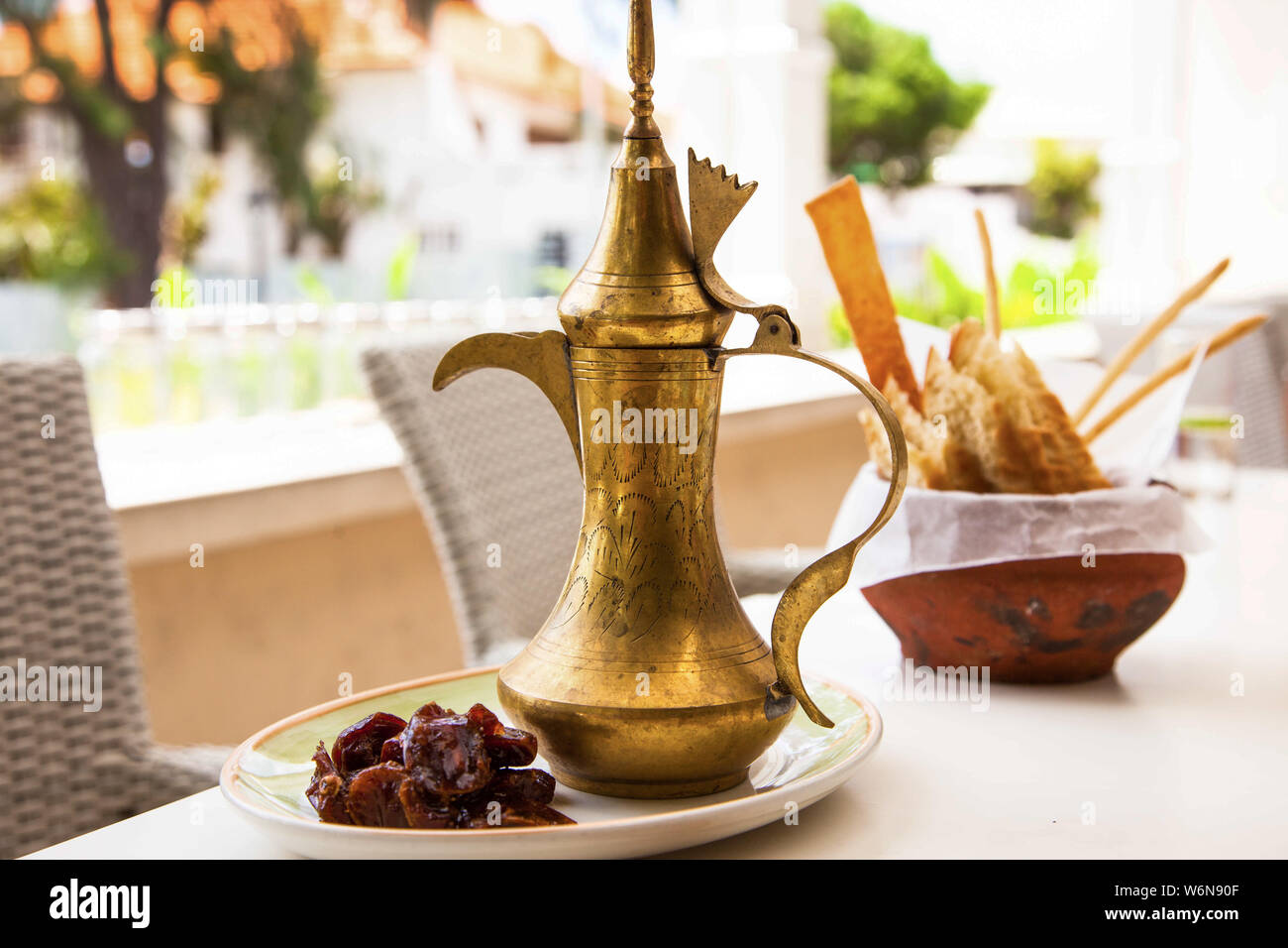 Arabic coffee in a traditional Turk with dates and snacks in a clay pot Stock Photo