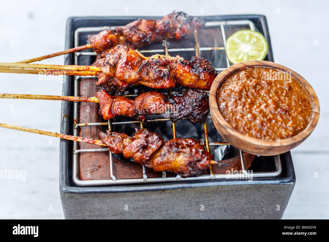 sate ayam high resolution stock photography and images alamy https www alamy com sate ayam chicken sate grilled meat on bamboo skewers traditional indonesian dish served with sambal kacang peanut sauce bali indonesia image262315402 html