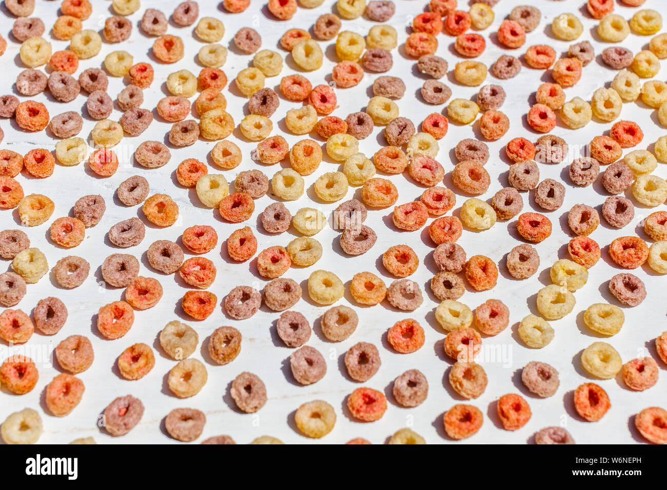 Colorful breakfast fruit loops on white background. Stock Photo