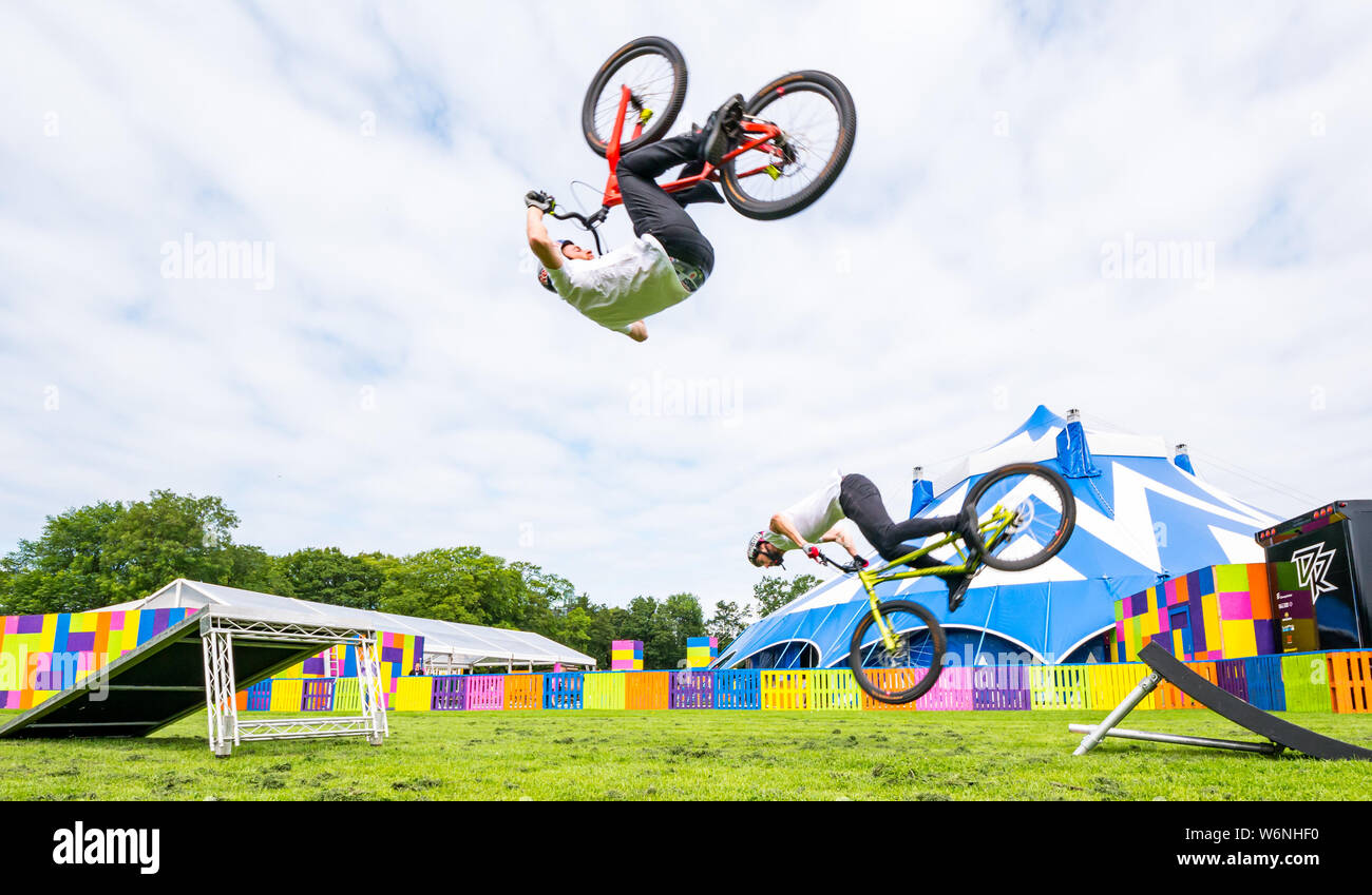 Edinburgh, Scotland, United Kingdom, 2 August 2019. Edinburgh Festival Fringe: Danny MacAskill’s Drop & Roll Live is on at Underbelly Circus Hun on The Meadows. Danny Macaskill and Duncan Shaw, trial bike riders show one of their cycle stunts from their show Drop & Roll Live Stock Photo