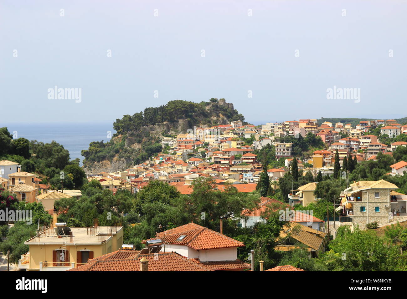 Panoramic view from the hill of the traditional Greek village of Parga and the venetian castle. Background view of blue sea and sky Stock Photo