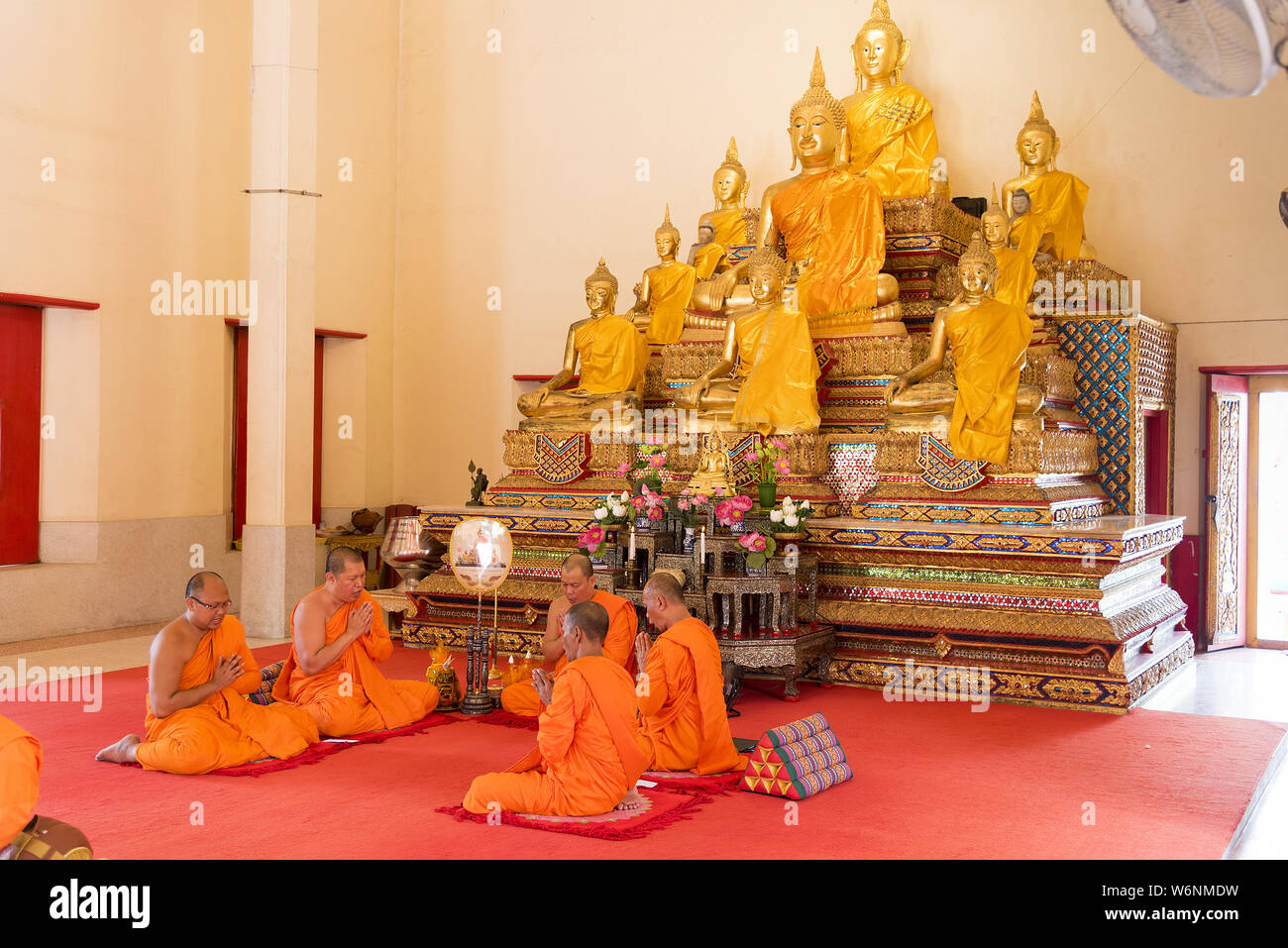 Phuket, Thailand, 04/19/2019 - Group of buddhist monks praying together at the Chalong Temple. Stock Photo