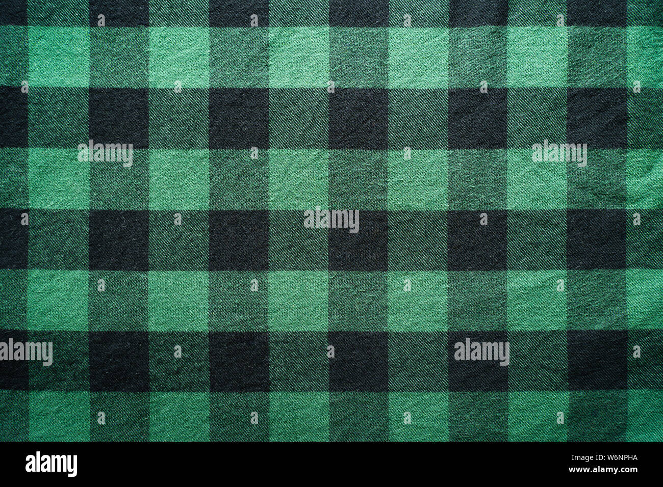 Fabric in a cage. Black and green square pattern. Clothes Empty Background Stock Photo