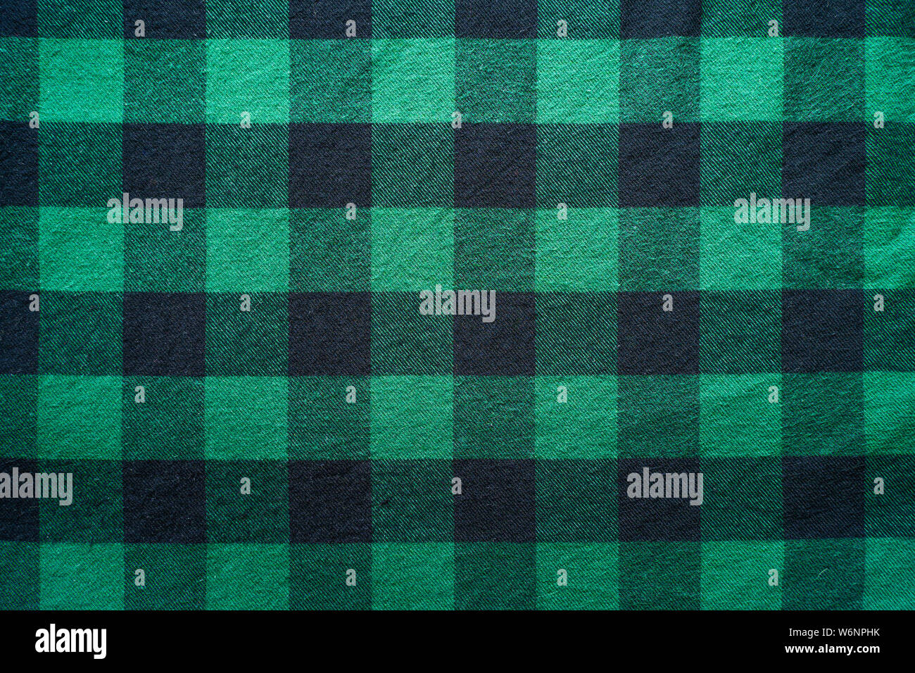 Fabric in a cage. Black and green square pattern. Clothes Empty Background Stock Photo