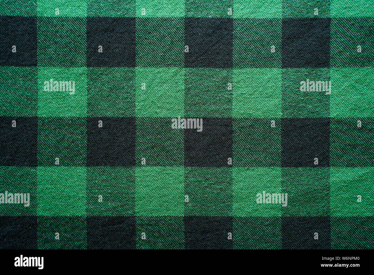 Fabric in a cage. Black and green square pattern. Clothes Empty Background Stock Photo