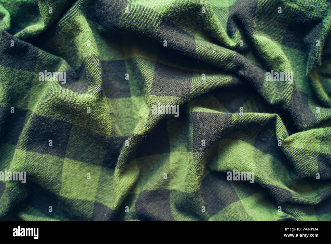 Fabric in a cage. Black and green square pattern. Crumpled Cloth Blank Background Stock Photo