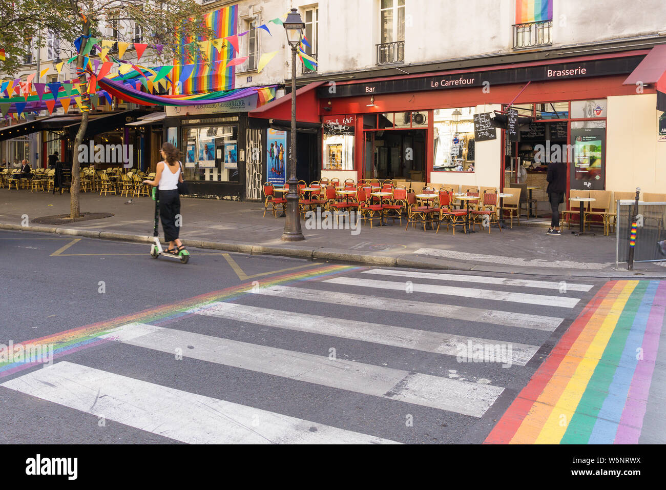 Paris street scene - scene on Rue des Archives, permanently coloured in rainbow symbols in the Marais district, Paris, France, Europe. Stock Photo