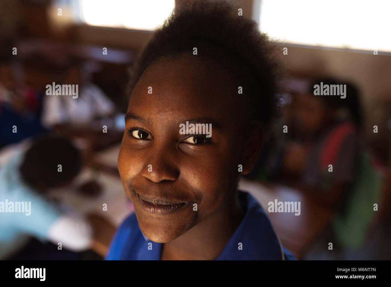 Portrait of young schoolgirl smiling to camera Stock Photo - Alamy