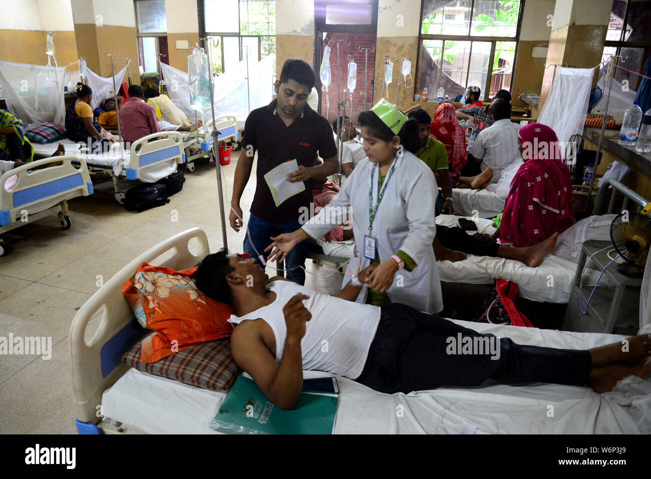 Dengue fever patients lying on the bed outside the Shaheed Suhrawardy Medical College Hospital’s
