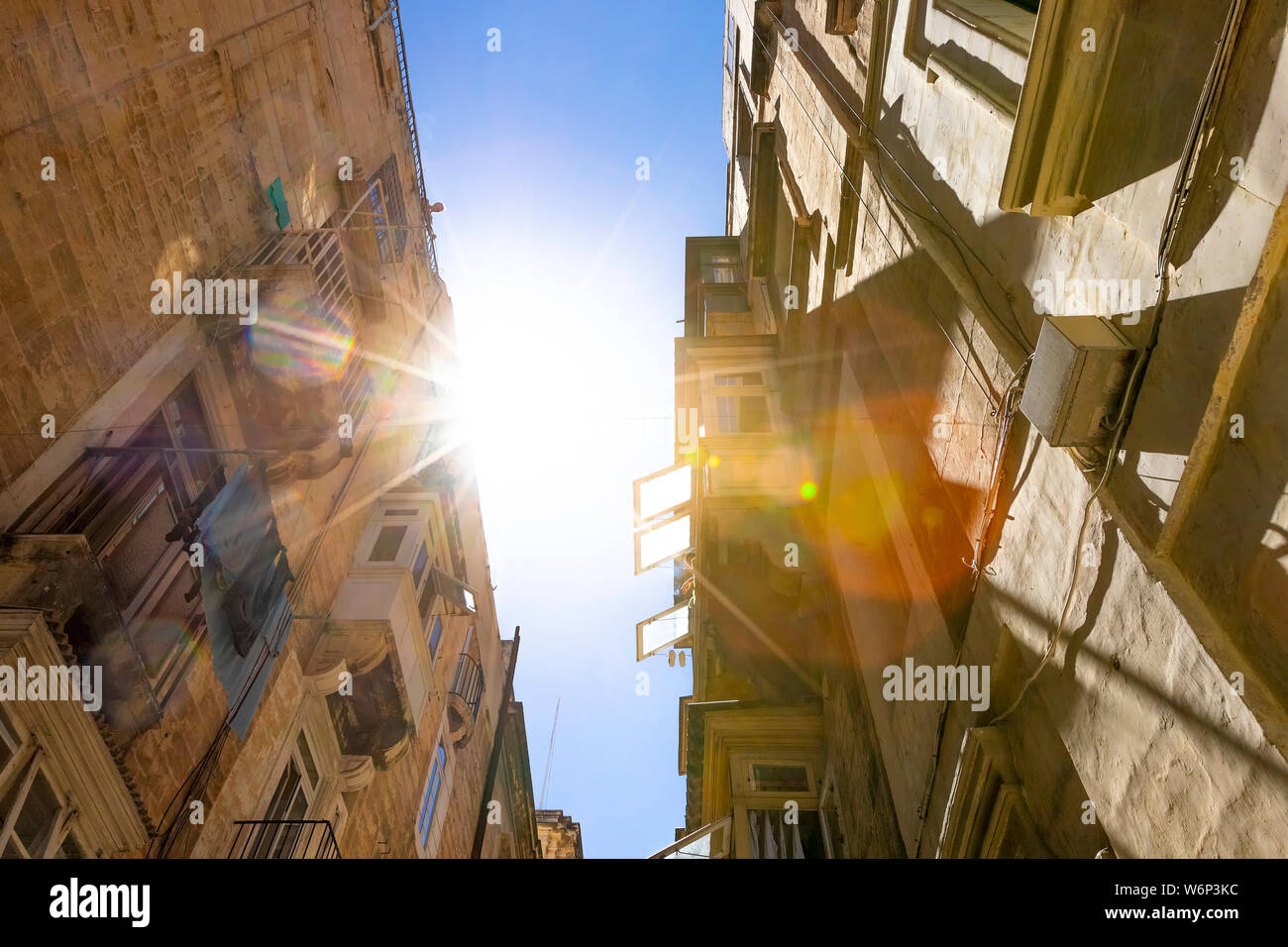Typical narrow maltese streets with colorful traditional windows and