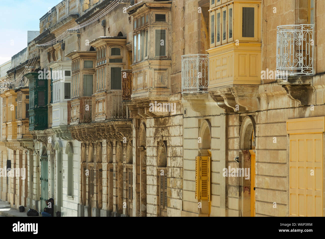 Typical narrow maltese streets with colorful traditional windows and