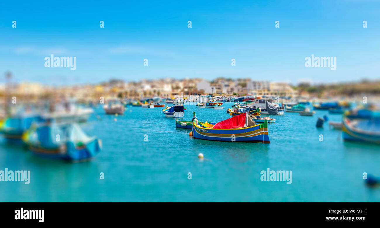 Maltese boats float in the harbor of Marsaxlokk, Malta. the fishing