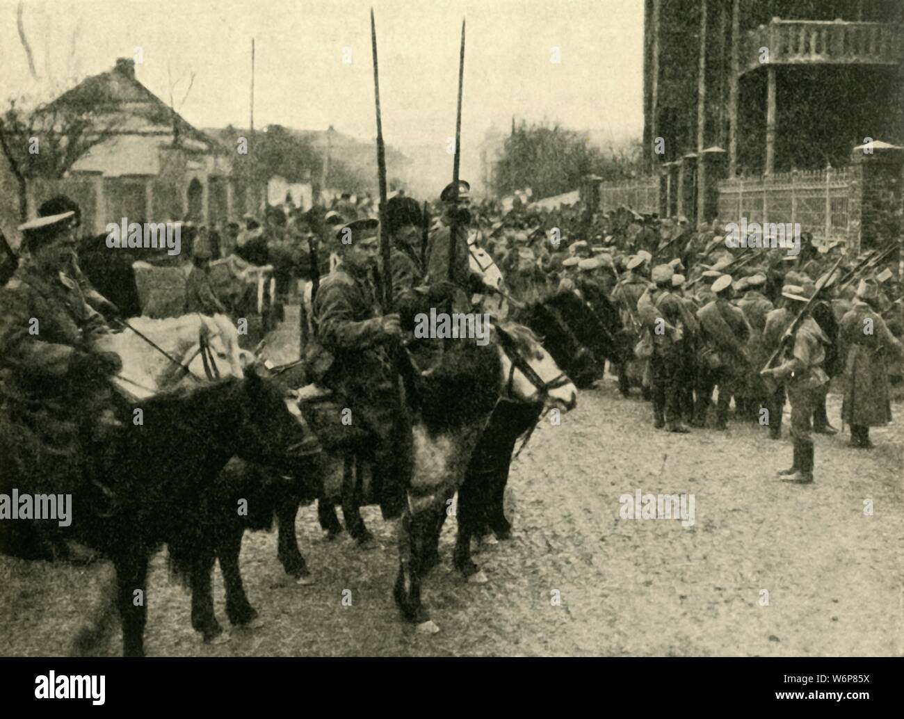 Cossack soldiers, First World War, 1914, (c1920). 'On the Heels of the Invader: a Cossack patrol occupying a Polish village. The German troops had been in occupation of this village only the night previous to the arrival of the Cossacks'. From &quot;The Great World War - A History&quot; Volume II, edited by Frank A Mumby. [The Gresham Publishing Company Ltd, London, c1920] Stock Photo
