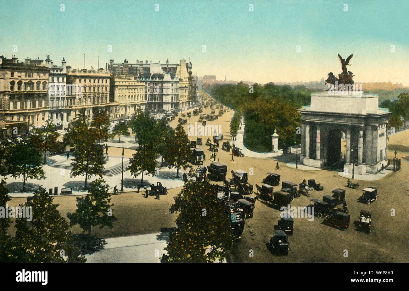 Piccadilly from Hyde Park Corner, London, c1915. View of the Wellington Arch, a triumphal arch in central London between Hyde Park and Green Park. It was designed by Decimus Burton and built 1826-1830, and once supported an equestrian statue of the 1st Duke of Wellington. The sculpture of the quadriga, (an ancient four-horse chariot), designed by Adrian Jones, has been mounted on it since 1912. Postcard. Stock Photo