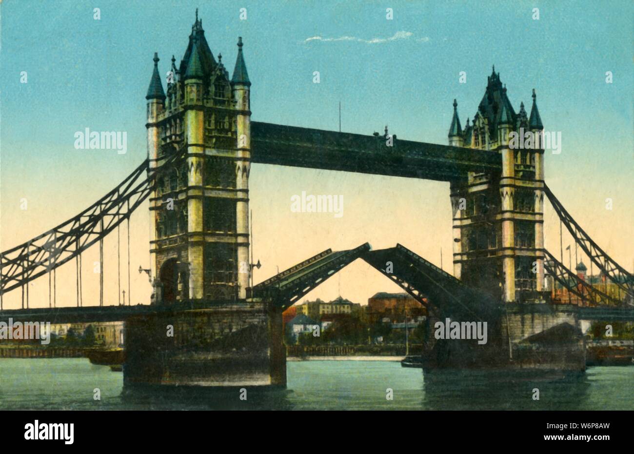 Tower Bridge, London, c1910. View of Tower Bridge with bascules open, and the River Thames. The construction of the bridge was begun in 1881 to designs by Sir Horace Jones and it opened in 1894. It was designed so that the central section could be raised to allow the passage of ships to and from the busy wharves of London. Postcard. Stock Photo