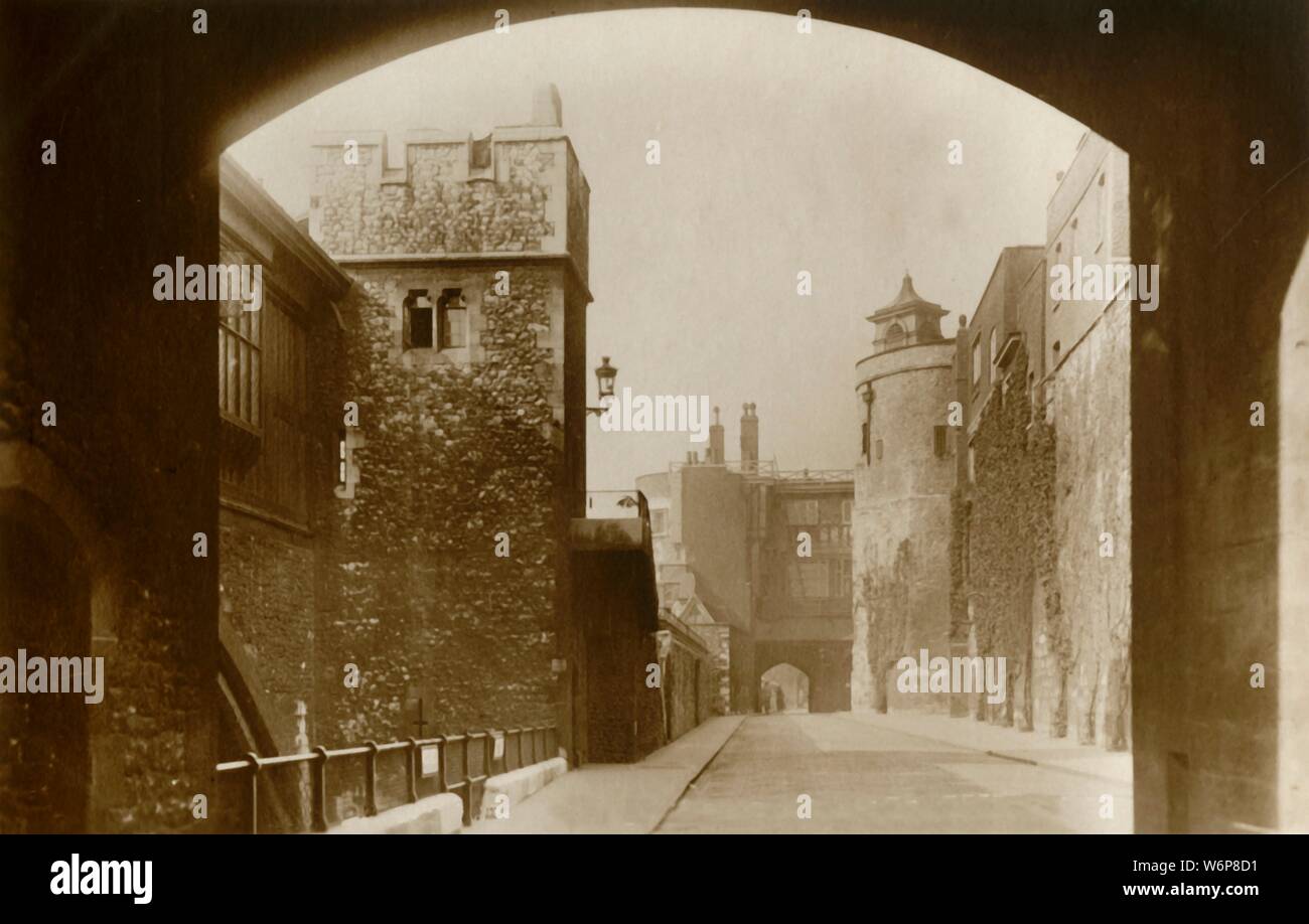 'Tower of London. St. Thomas's and the Bell Tower', c1910. View of part of the Tower of London - historic palace, prison, fortress and armoury - which dates from the 11th century. 'The twelve Towers of the Inner Ward were at one time all used as prisons. St. Thomas's Tower stands above the Traitors' Gate, and both of them date from the reign of Henry III. The Bell Tower was the prison of Princess Elizabeth [later Queen Elizabeth I], and previously of Cardinal Fisher and Sir Thomas More, who were put to death in 1535.' Postcard. [Raphael Tuck &amp; Sons] Stock Photo