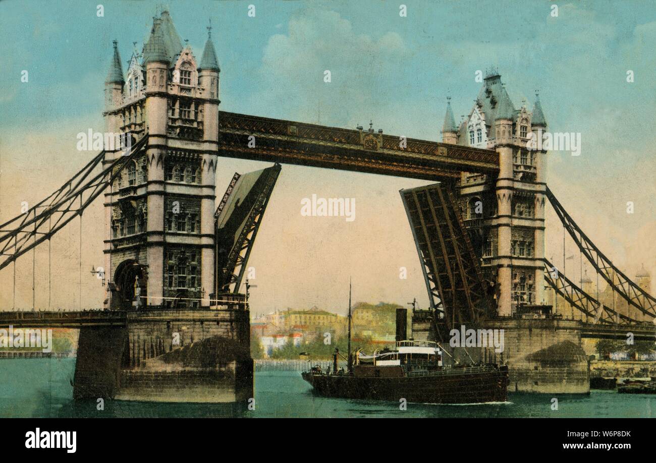 Tower Bridge, London, 1915. View of Tower Bridge over the River Thames, with a ship passing under the raised bascules. The construction of the bridge was begun in 1881 to designs by Sir Horace Jones and it opened in 1894. It was designed so that the central section could be raised to allow the passage of ships to and from the busy wharves of London. Postcard. Stock Photo